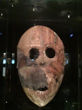 This limestone, asphalt, and pigmented mask was found in the world's oldest cultic hoard along with parts of statues, textiles, beads