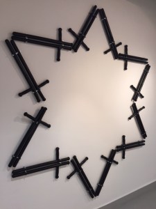 Billy clubs arranged in a Jewish star.  You might call this a work taking off from Duchamp's readymades.