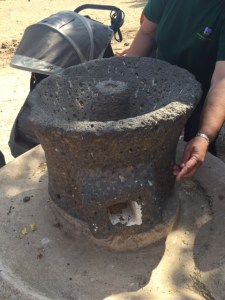 An ancient grain mill that would have been turned by animals to grind the wheat into flour.  The guide estimated this one from about 100 BCE.