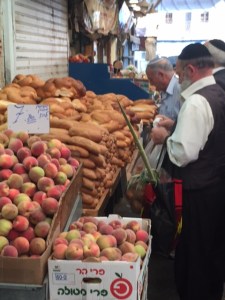 Here you can see the lulav sticking out of the shopping bag. We have seen people carrying them everywhere.