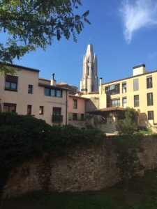 You can see the tower of St. Feliu over modern apartment buildings and a reconstructed wall below.