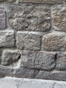 At the base of one of the walls there is a stone with engraved Hebrew letters (turned on its side).  This is a Jewish gravestone.