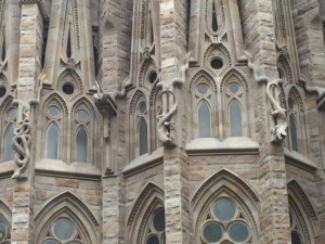 Serpents and lizards slide down the face of the side structures.