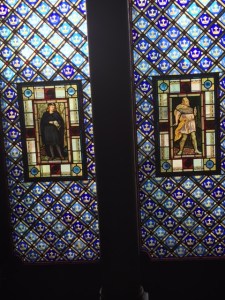Stained glass window with Shakespearean characters in a pre-Raphaelite style and William Morris pattern (Arts and Crafts movement).